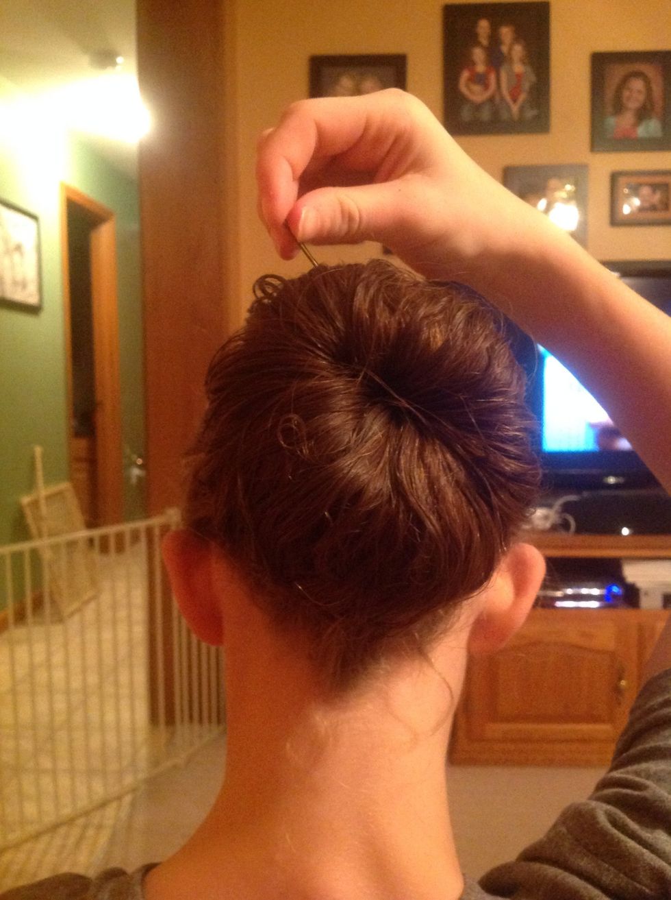 Add hair pins to secure bun.