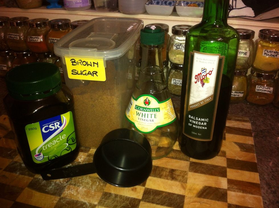 Add half a cup of white vinegar and half a cup of balsamic vinegar. This will form the base of the sauce. To balance the sourness add half a cup of brown sugar and half a cup of treacle