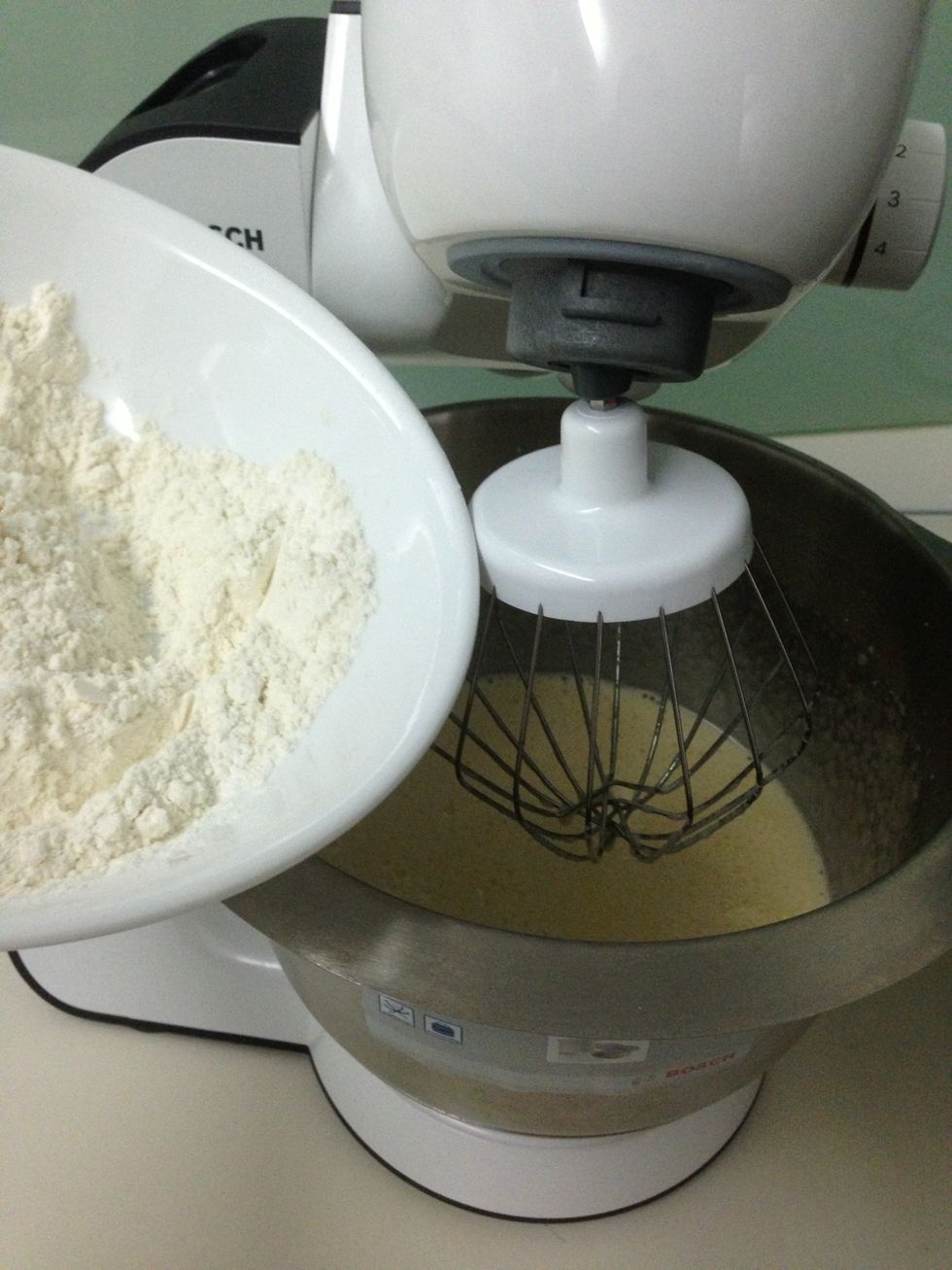 Add half of the flour and mix