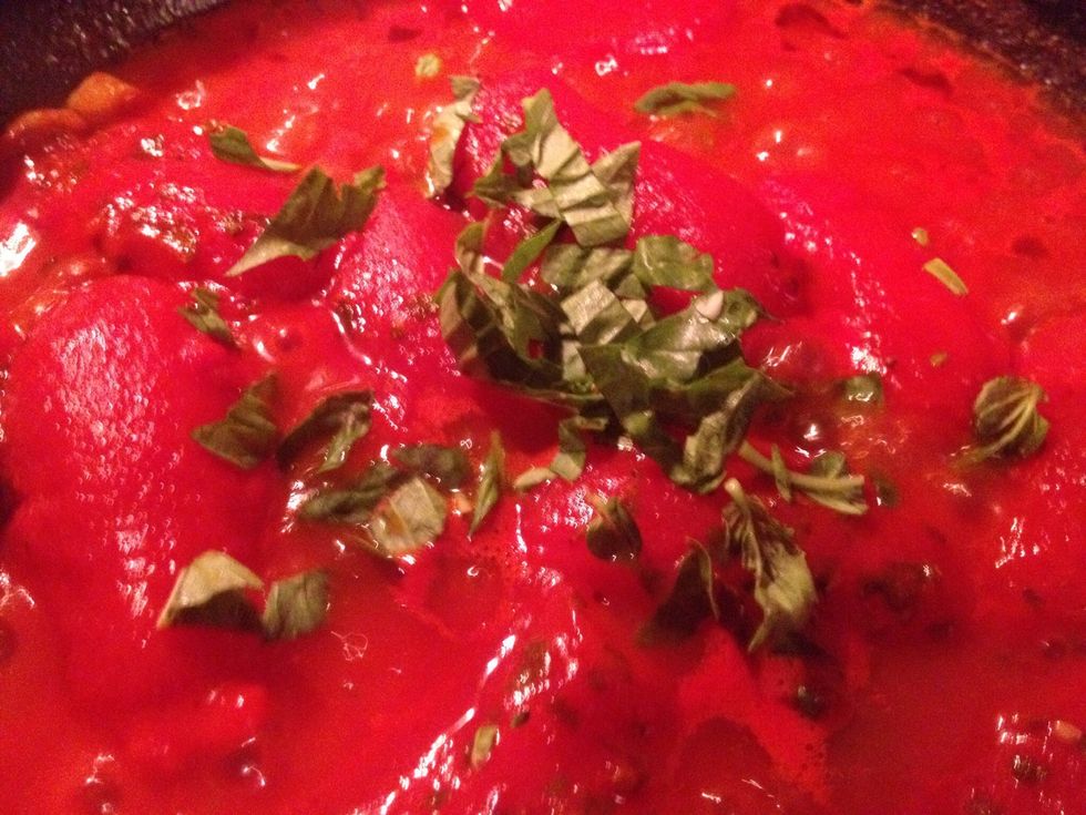Add half of the fresh basil leaves and cook for another minute