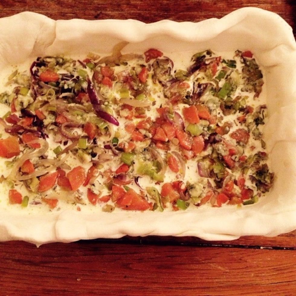 Add half of the onion and cheese mix, then cover with some more cream and eggs. Repeat with the remaining onion and stilton mix