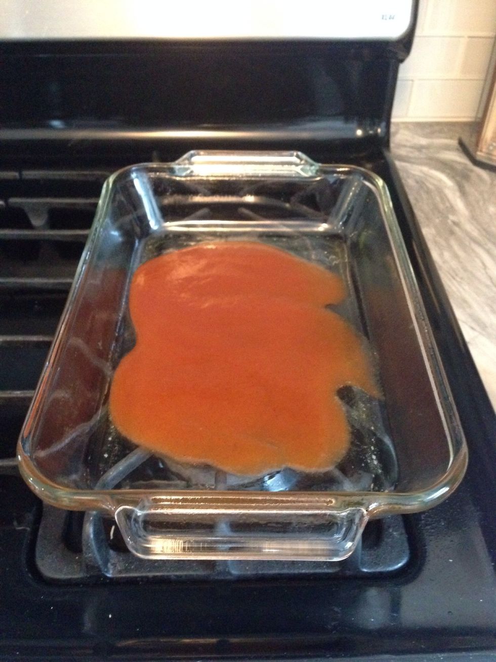 Add half of the remaining enchilada sauce to the bottom of the pan.