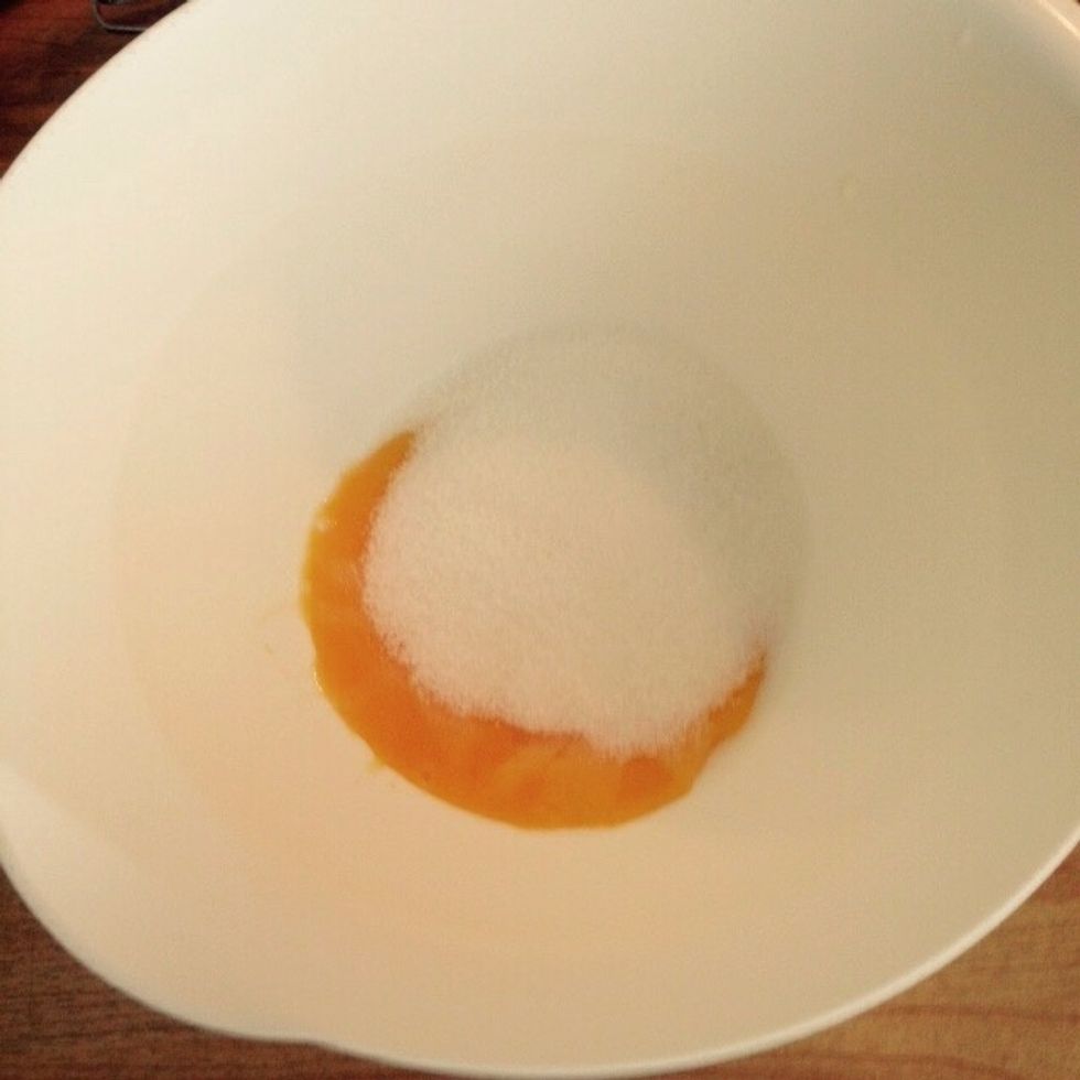 Add half of the sugar to the yolks
