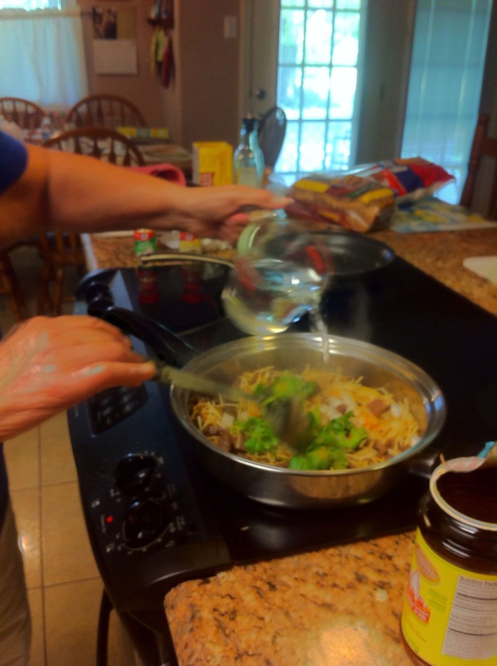 Add half of the warmed water and cover for about 2 minutes. Then, add the rest of the water and cover for a final 5 to 7 minutes more.