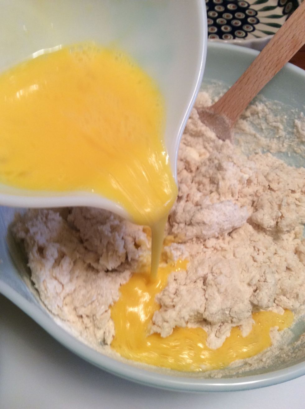 Add half the eggs. Stir.