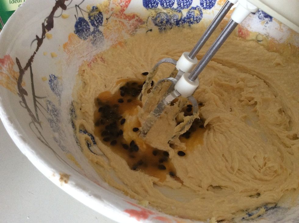 Add half the passion fruit, sour cream, flour and coconut