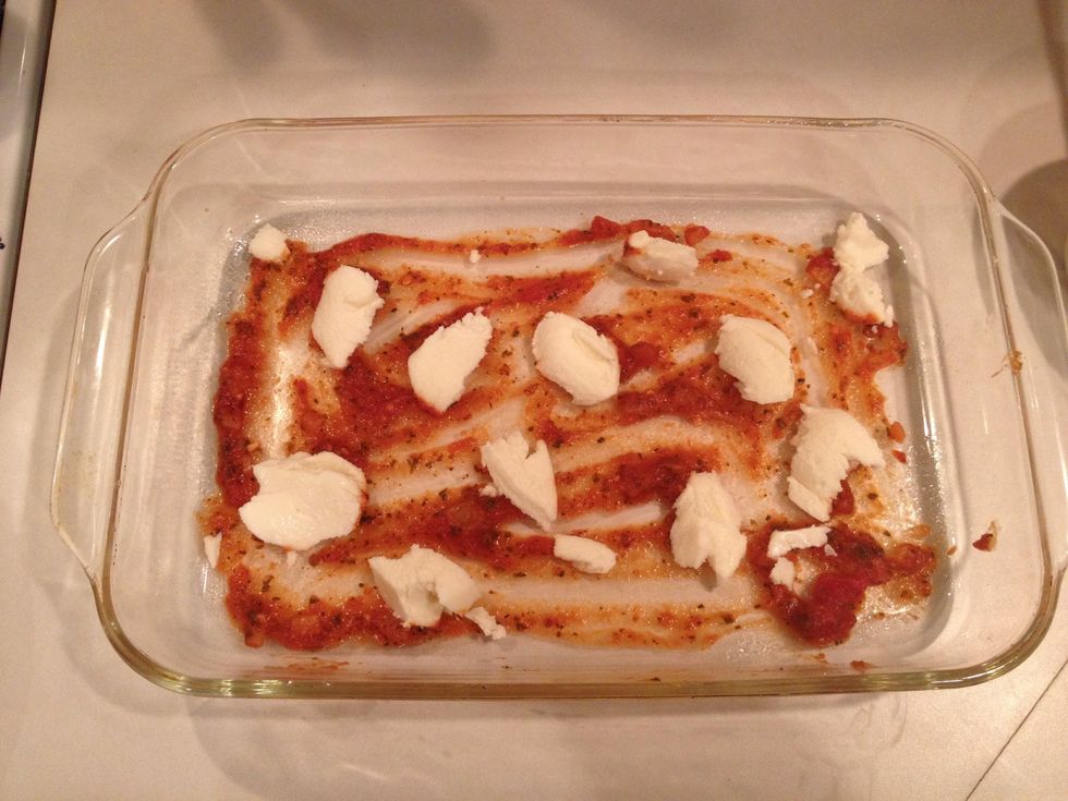 Add half the ricotta cheese to the sauce in small dabs.