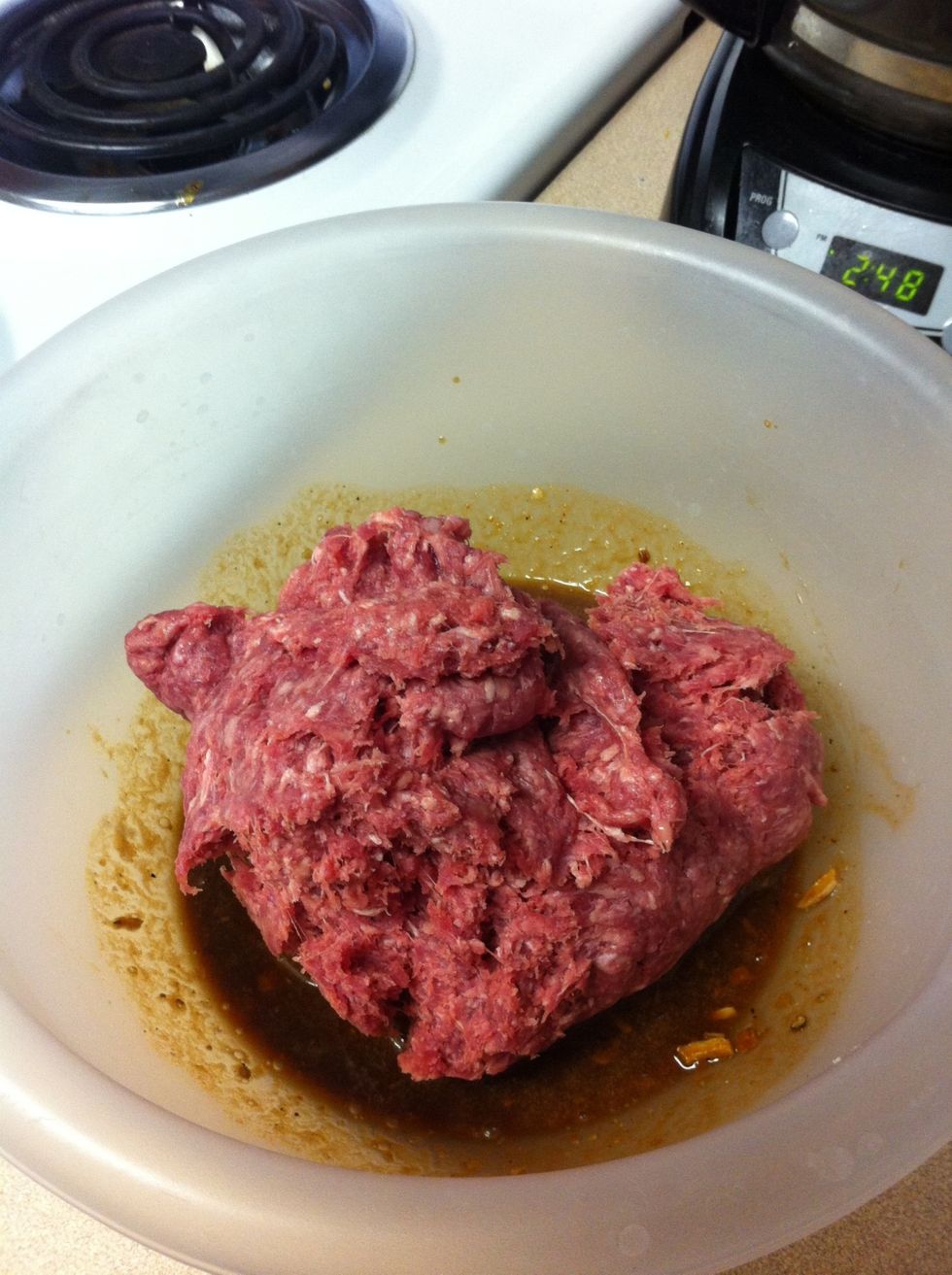 Add hamburger. With hands, mix well.