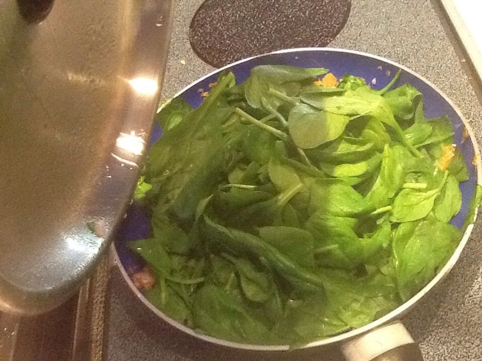 Add handfuls spinach to onion mixture, cover to steam.