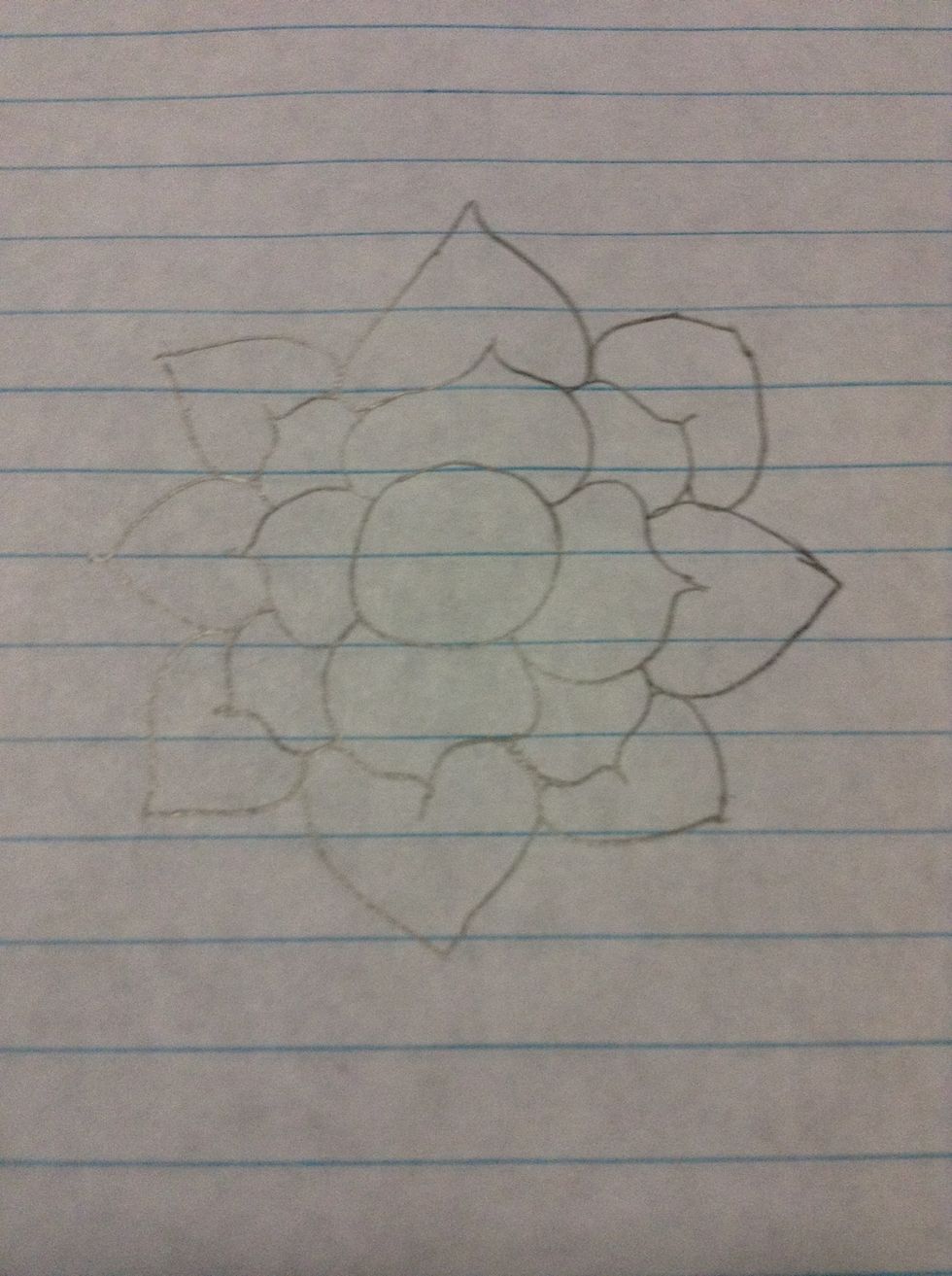 Add heart like shapes around the petals you already made.