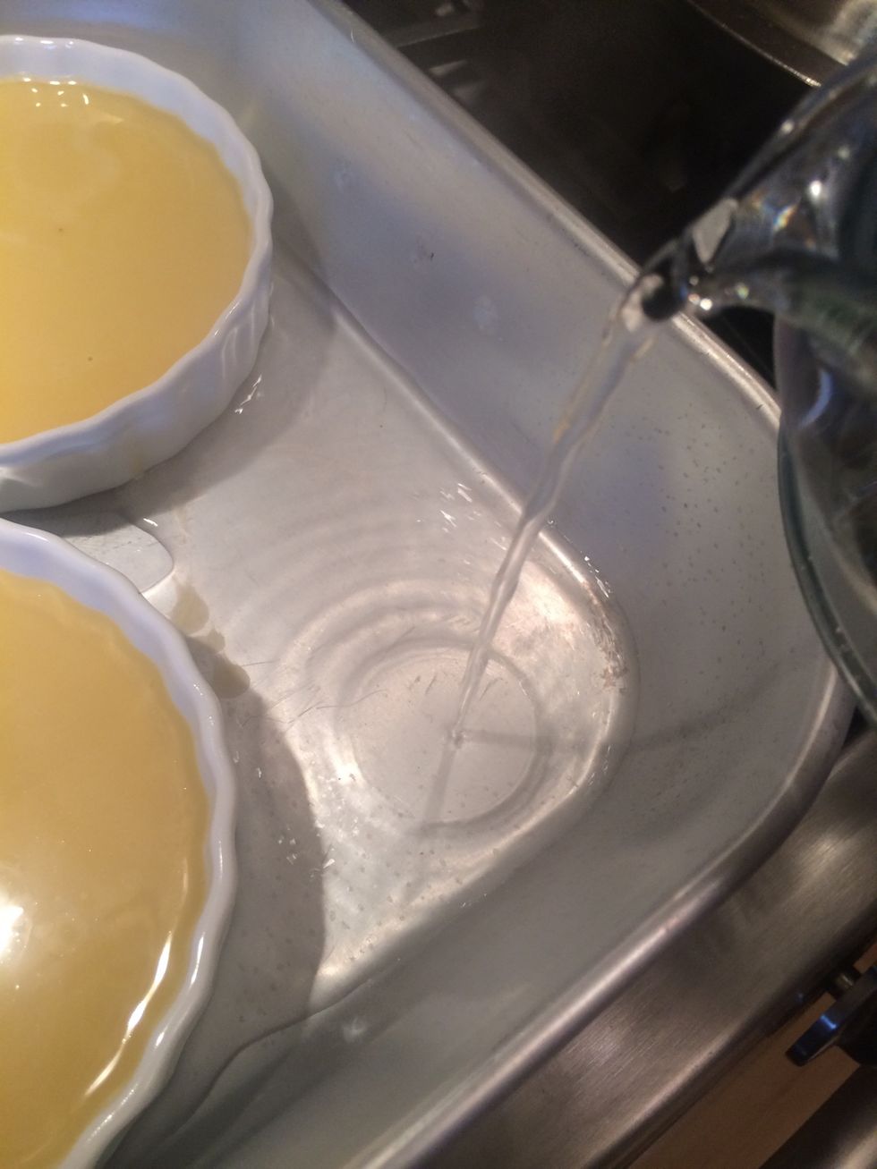 Add hot water to roasting pan, creating a "water bath".