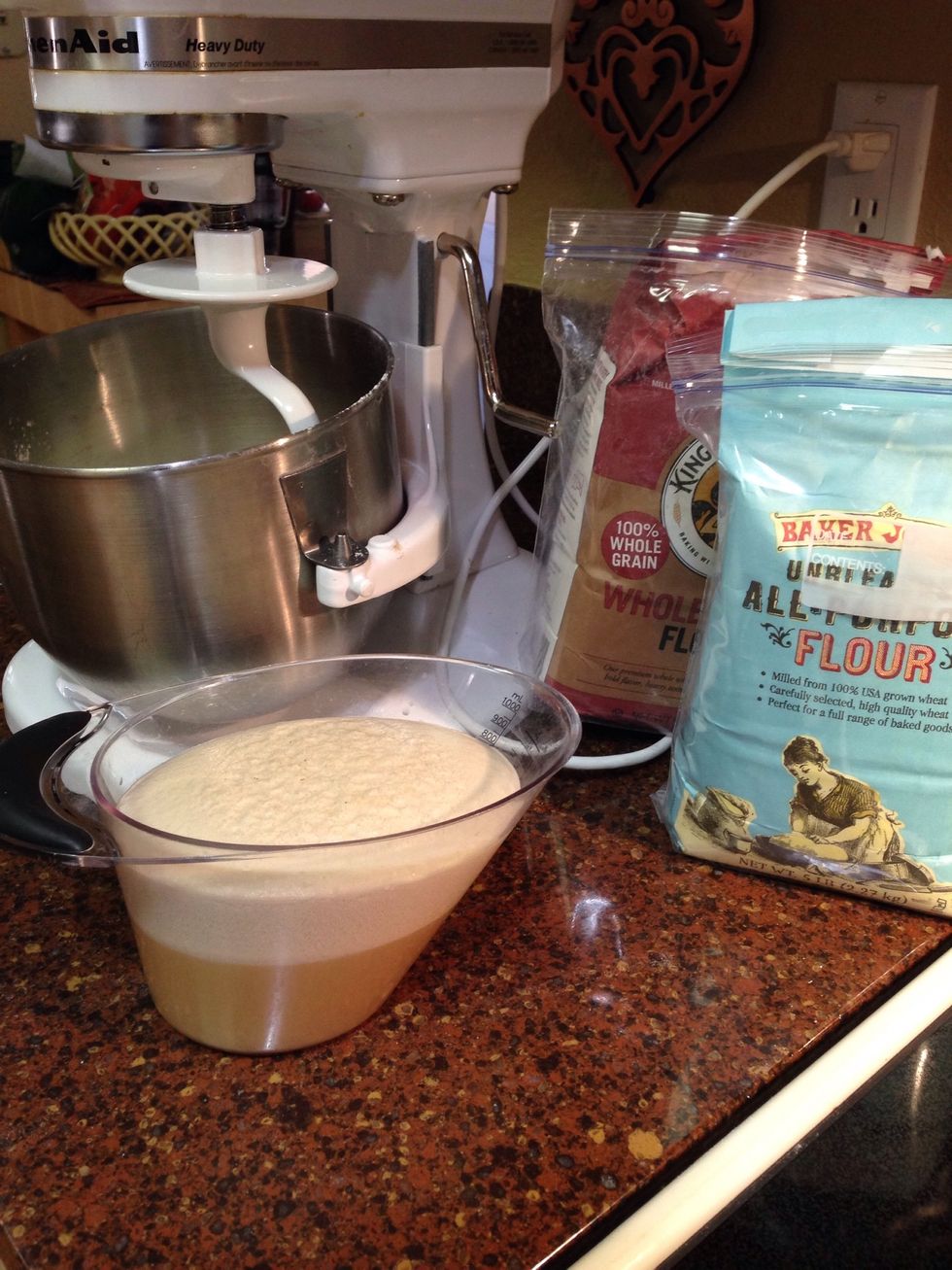 Add hot water, yeast, sugar, & salt. Mix well & let stand to get foamy while measuring flour.  Measure 4 1/2 cups flour into mixing bowl (I use stand mixer w/ dough hook but this can be done by hand)