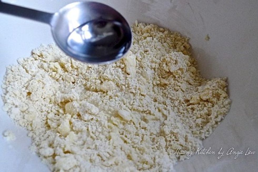 Add ice cold water, a tablespoon at a time, into the flour mixture.