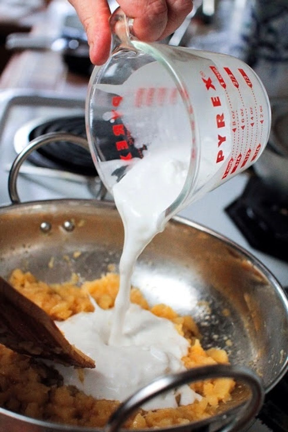 Add in 1 cup of coconut milk. Stit until all the coconut milk is dissolved.
