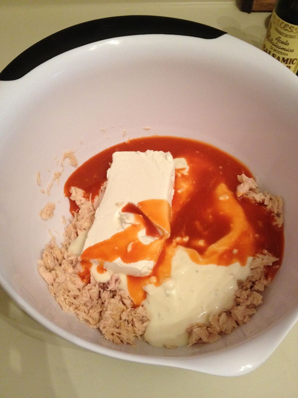 Add in 8oz of Reduced Fat Cream Cheese, 1 cup of Lite Chunk Blue Cheese Dressing, 1/2 cup of Texas Pete Buffalo Wing Sauce, & a small handful of Sharp Cheddar Cheese Shredded.