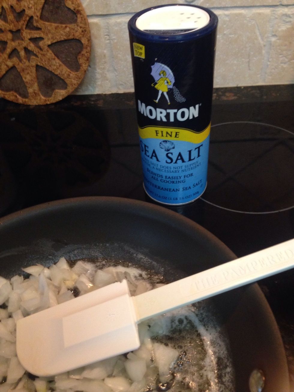 Add in a dash of sea salt for taste and to sweat those onions some.