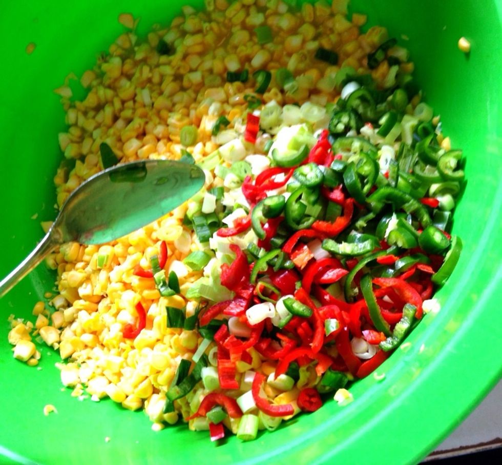 Add in all of the chilis and garlic to the corn mixture. You may also add the salt, ground cumin, garam masala and curry powder