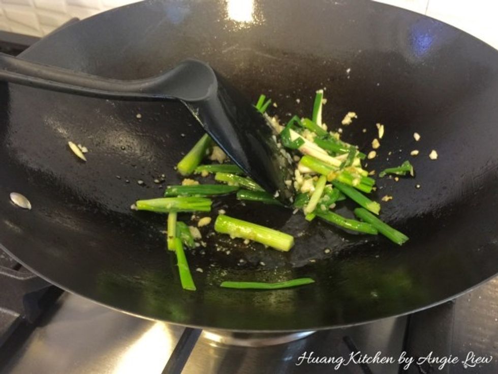 Add in chopped garlic and spring onions. Saute till fragrant, about 2 minutes.