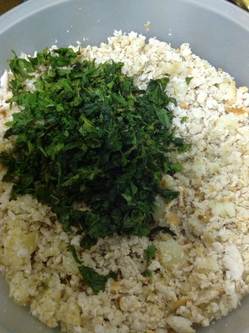 Add in chopped mint to grated breadcrumbs and potatoes. Potatoes must be boiled in stock water (chicken spice, mixed herbs, salt in water to form stock)