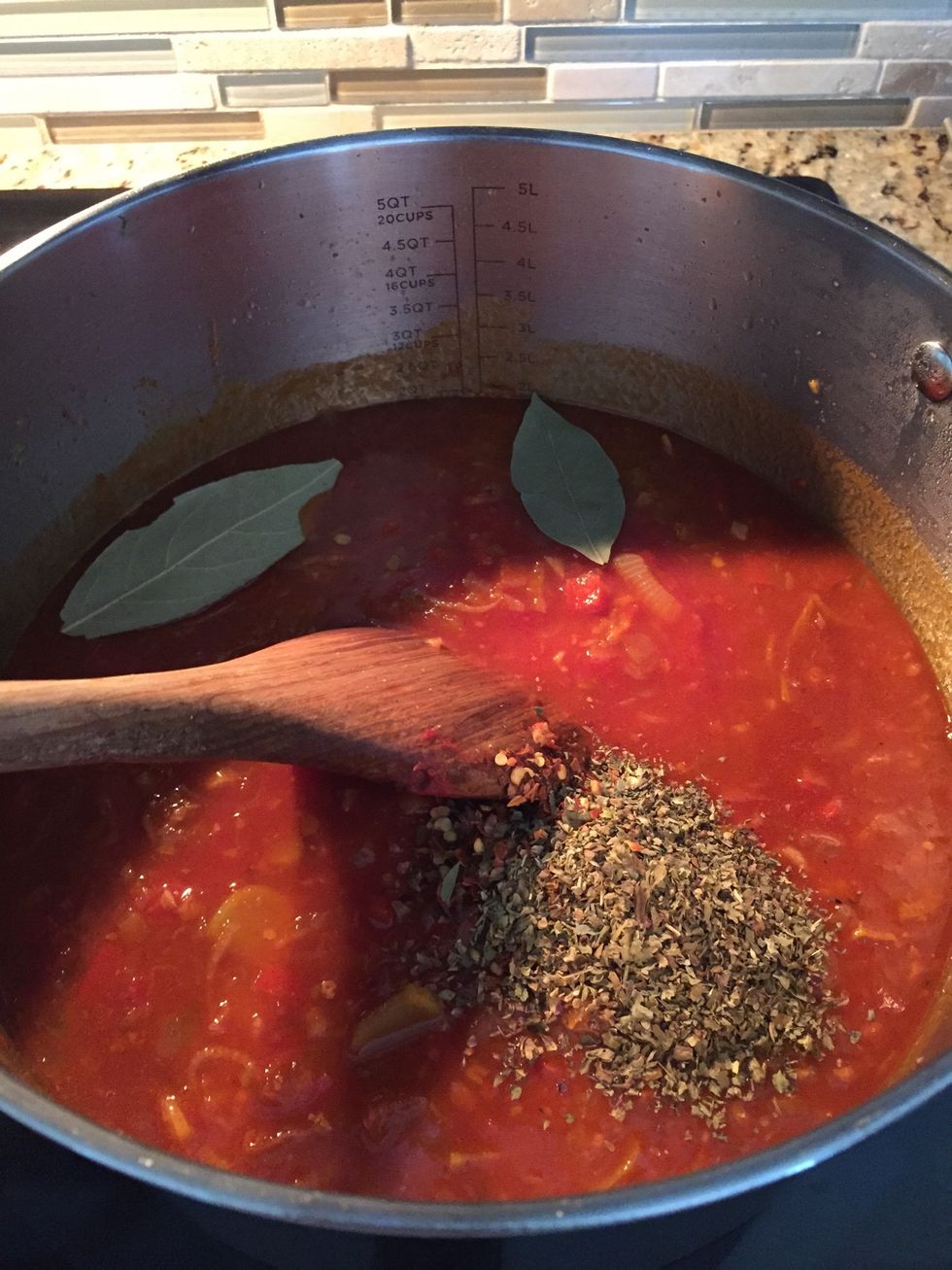 Add in crushed tomatoes, clam juice and dried spices
