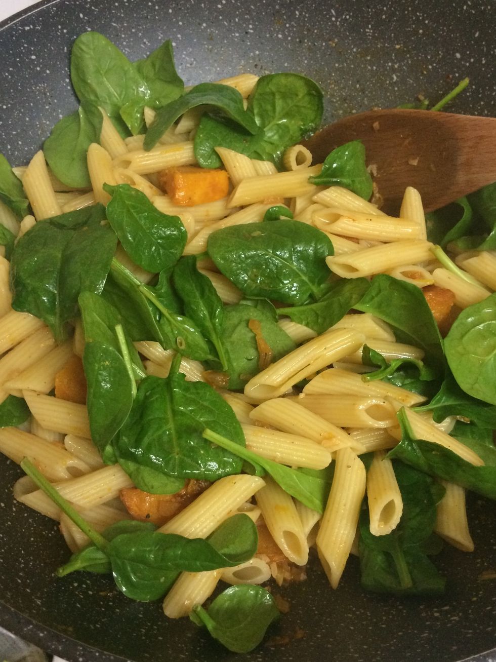 Add in penne pasta, spinach and stock and start stirring, then start seasoning with some salt and pepper