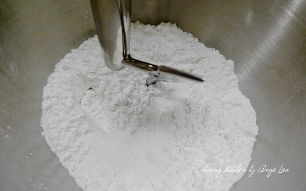 Add in salt followed by sugar and using a dough hook on low speed, mix everything till well combined.