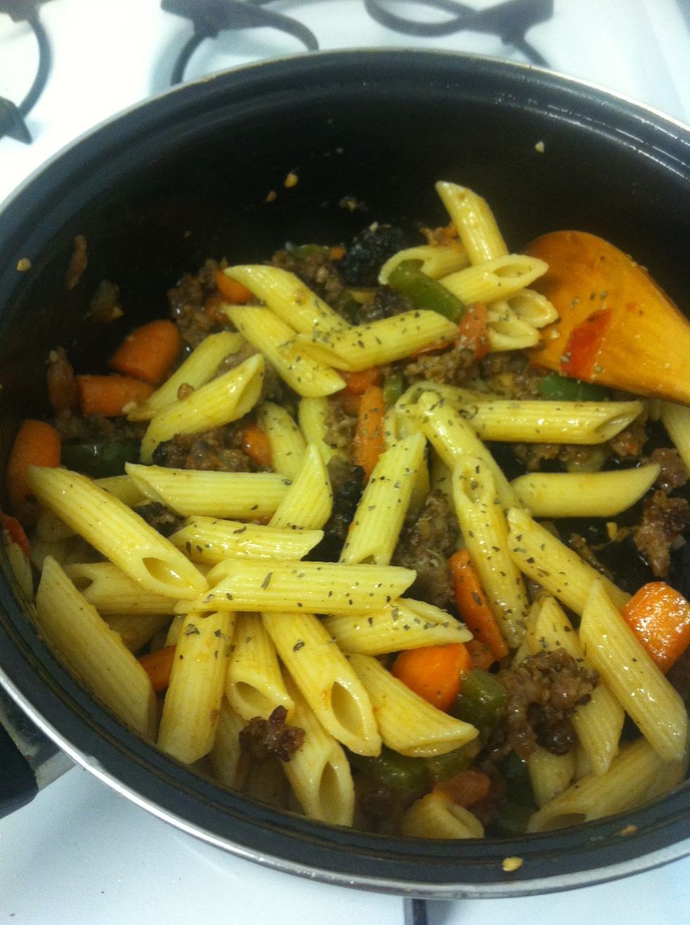 Add in sausage, pasta and cheese. Season with basil. Cook a few more mins to incorporate.