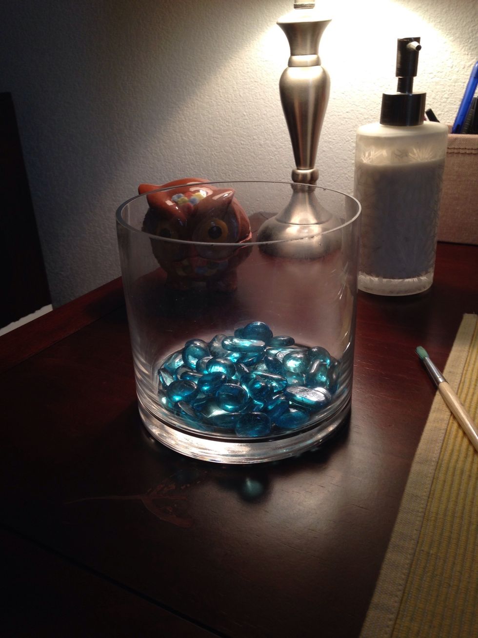 Add in some glass beads/marbles until the glass vase is about 3/4's of the way full.
