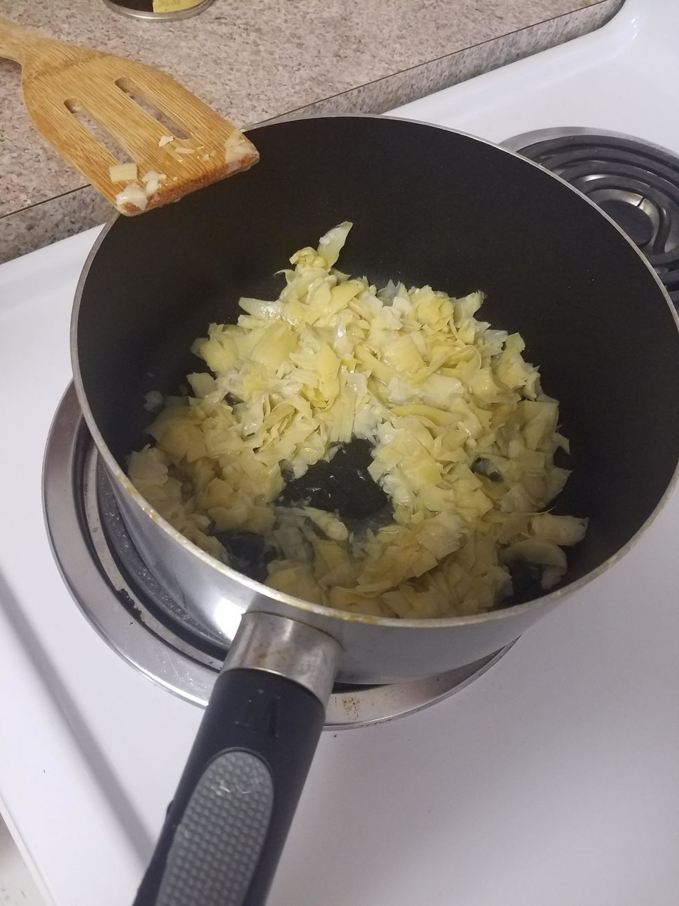 Add in the artichoke pieces and cook for one minute. Reduce heat to medium