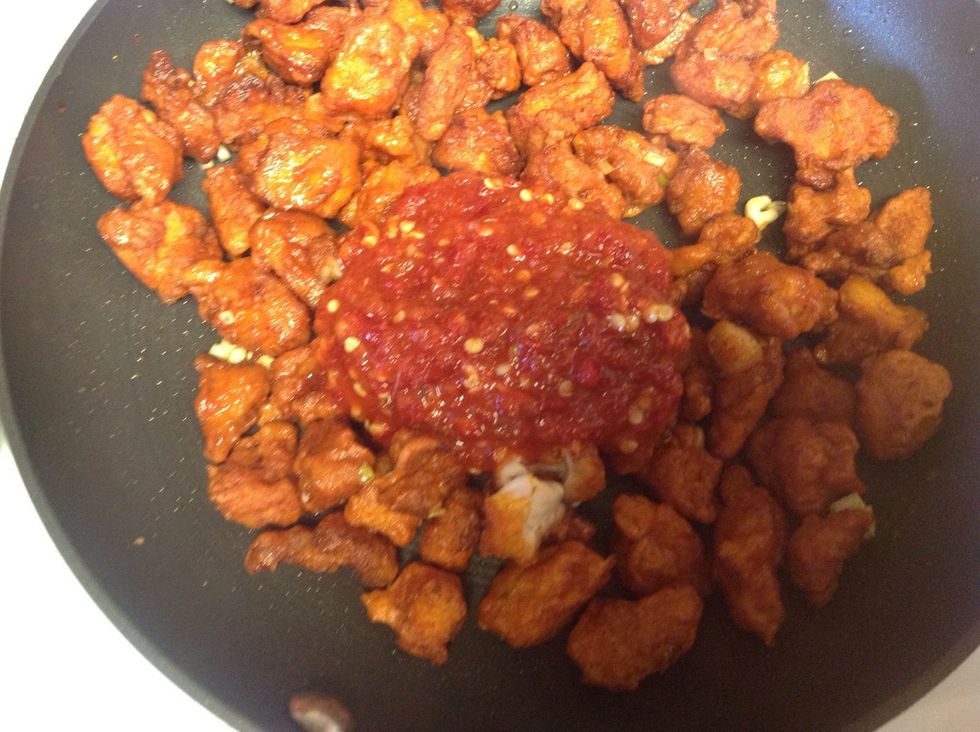 Add in the chicken to the pan and add the sauce. I added 3 tablespoons, you can according to your taste. Mix well