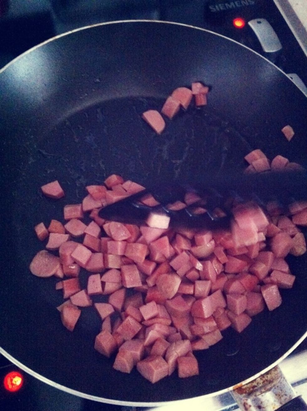 Add in the chopped hotdogs. Bacon bits would be perfect but i ran out of it at home so this is replacement.