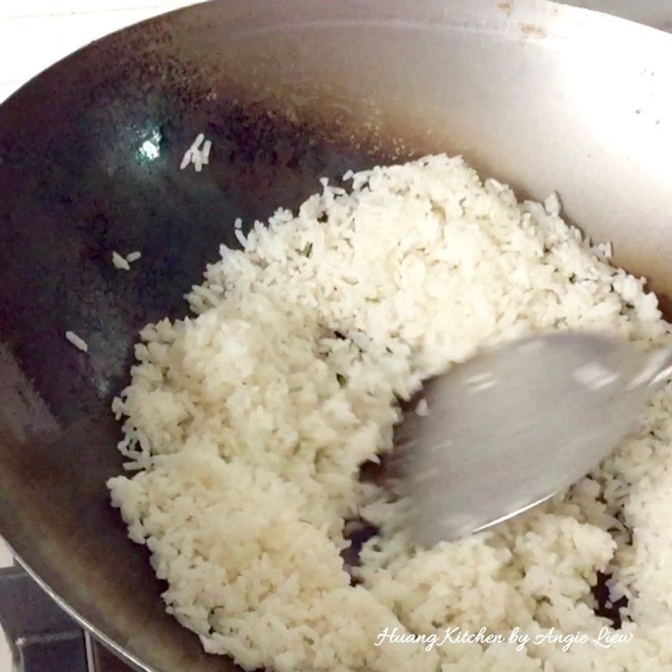 Add in the cooked rice. Fry the rice for about 1 to 2 minutes until it is heated through. Use the back of the ladle to gently tap and break up rice or clumps in the rice, if any.