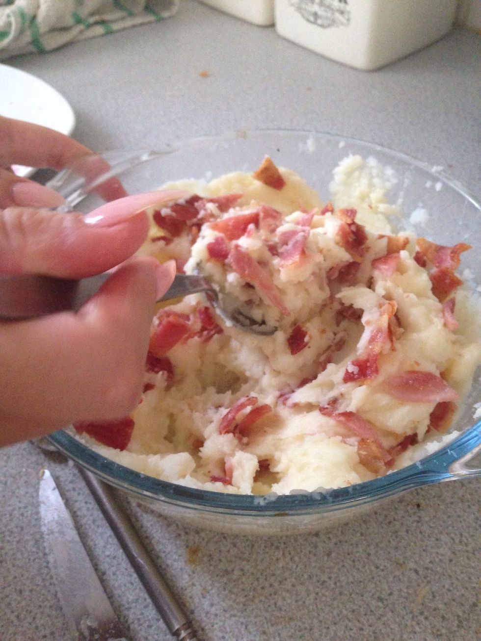 Add in the crispy fried bacon to the mixture and stir it through with a spoon