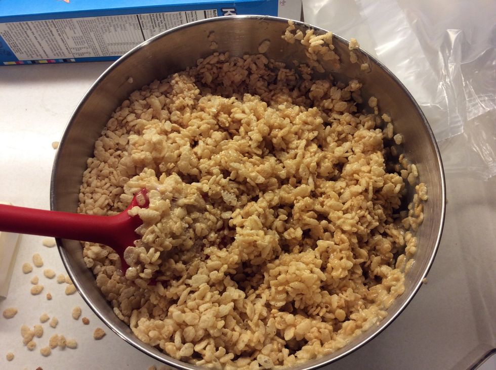 Add in the melted butter and marshmallow mixture and stir until they are together