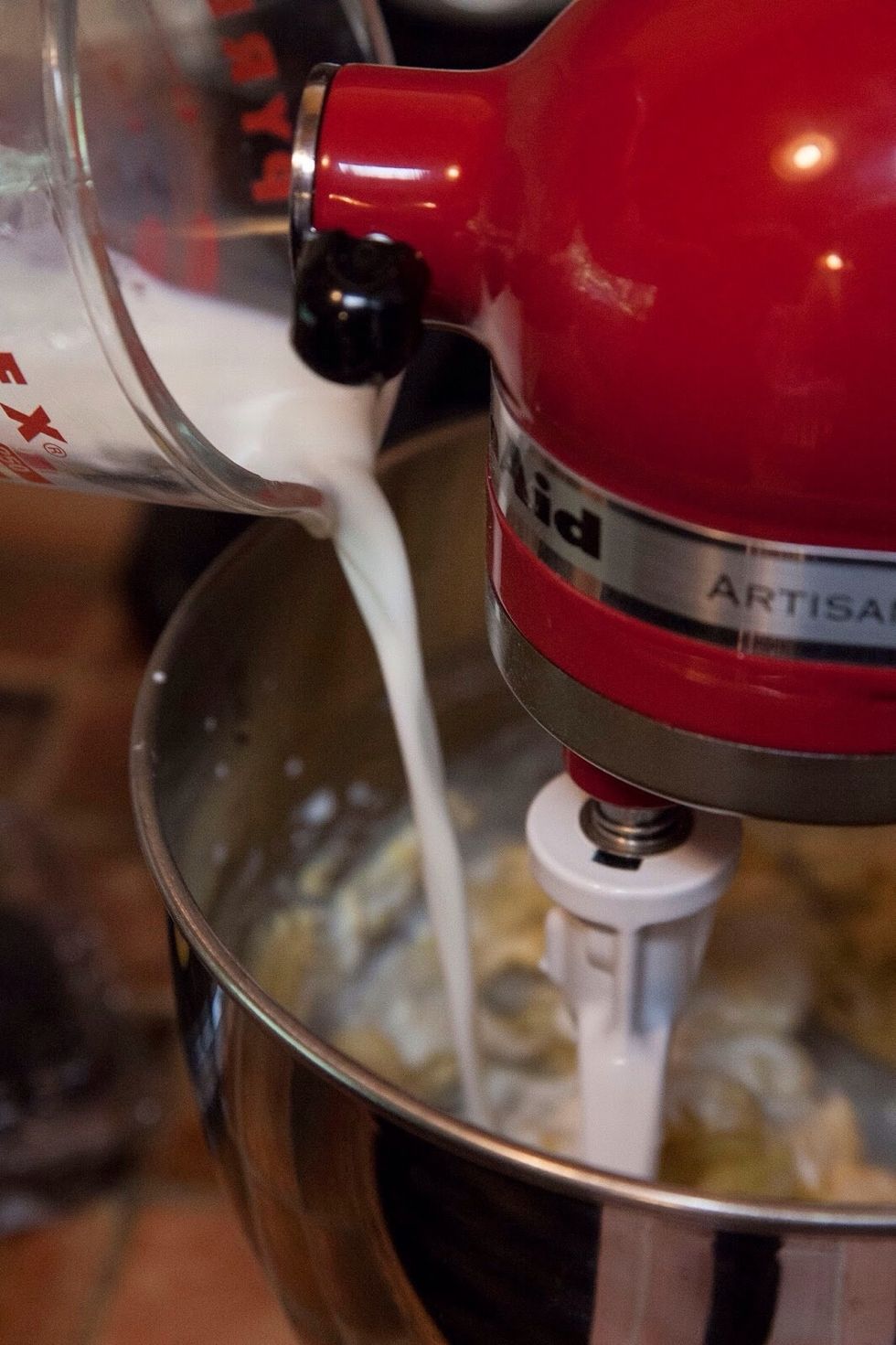 Add in the milk. Beat the cake batter with an electric beater on the high setting for about 3 minutes. It will turn yellow.
