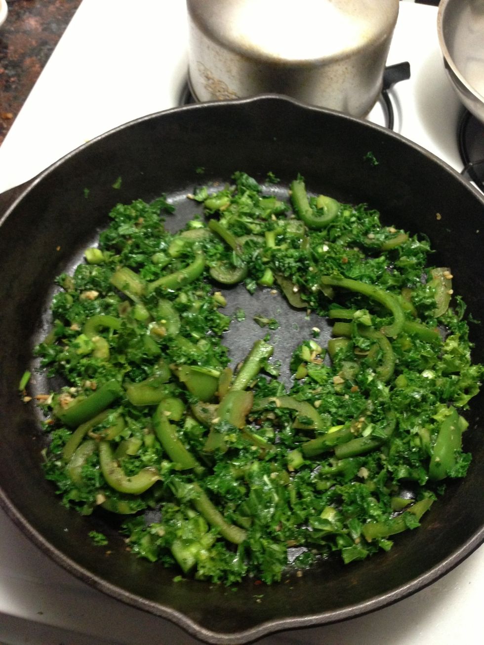 Add in the peppers 1st let them cook with the 6 pressed  garlic and then after a few minutes add in the kale and add the 2nd sauce lil by lil