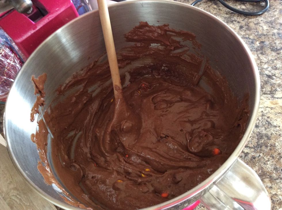 Add in the rest of the ingredients for the cake,  mix all together then add in the cup of Reeses Pieces. Stir the latter in by hand to avoid crushing them