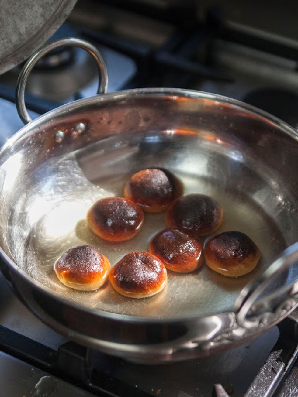Add in your baked Gulab Jamuns and let them simmer for 2 minutes, then turn off the heat and let them soak in the syrup for at least 1/2 hour.