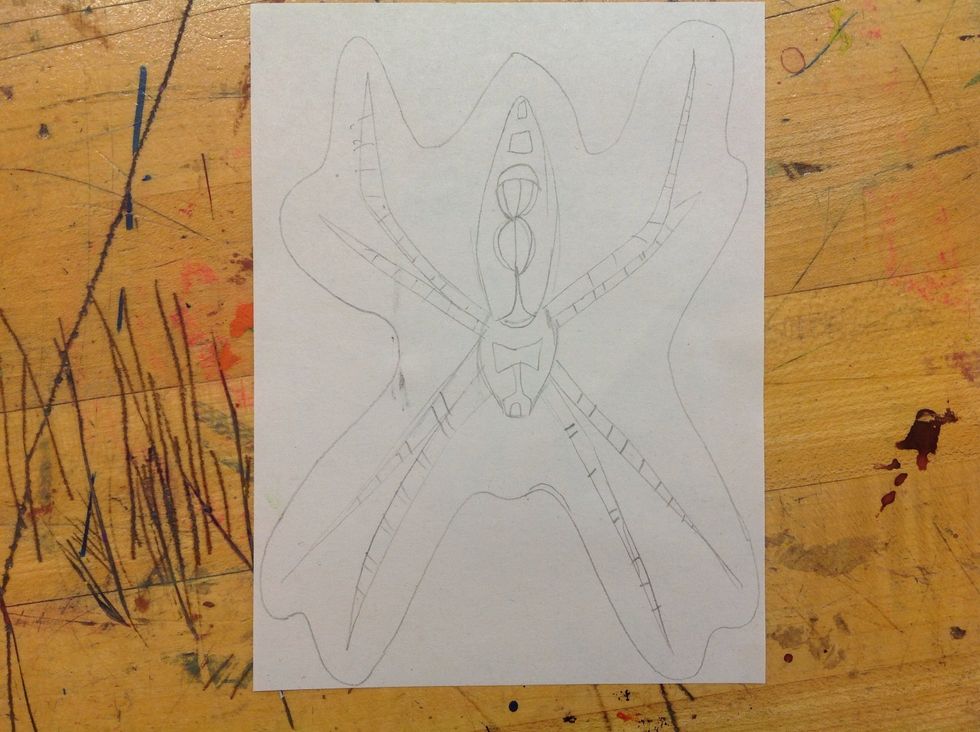 Add in your line and shape details to make the print more interesting. Draw a line around your insect so that it is easier to cut.