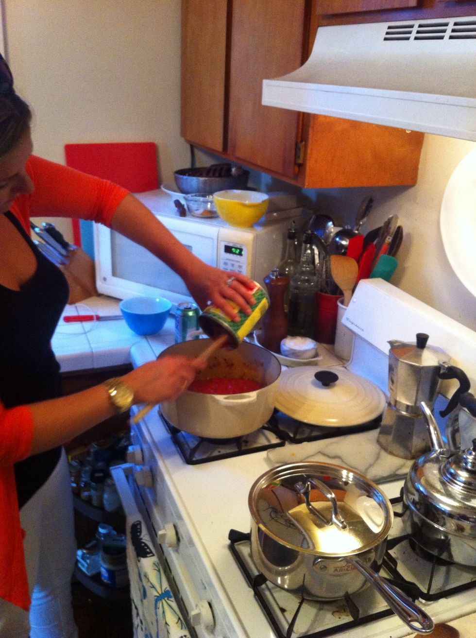 add in your tomato can (with the salt and sugar) bring it up to a boil, then drop it to medium-low and walk away. well not too far. stir it here and there. cook for about 15 minutes.