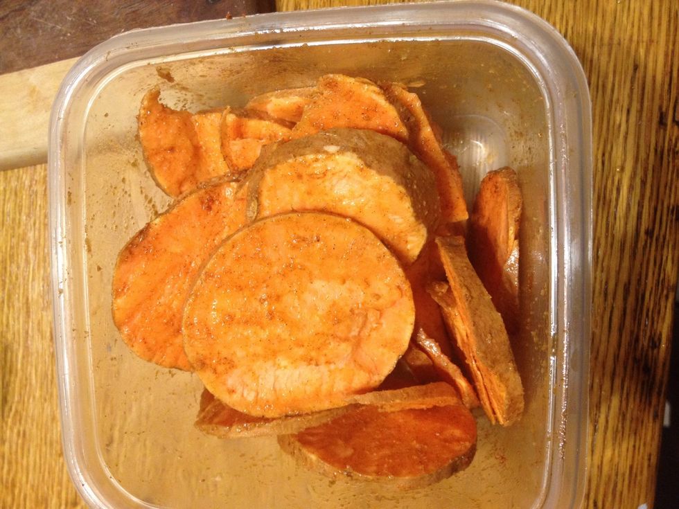 Add ingredients to sliced potatoes and make sure to coat well, especially the oil... Add more or less spiced to suite your taste