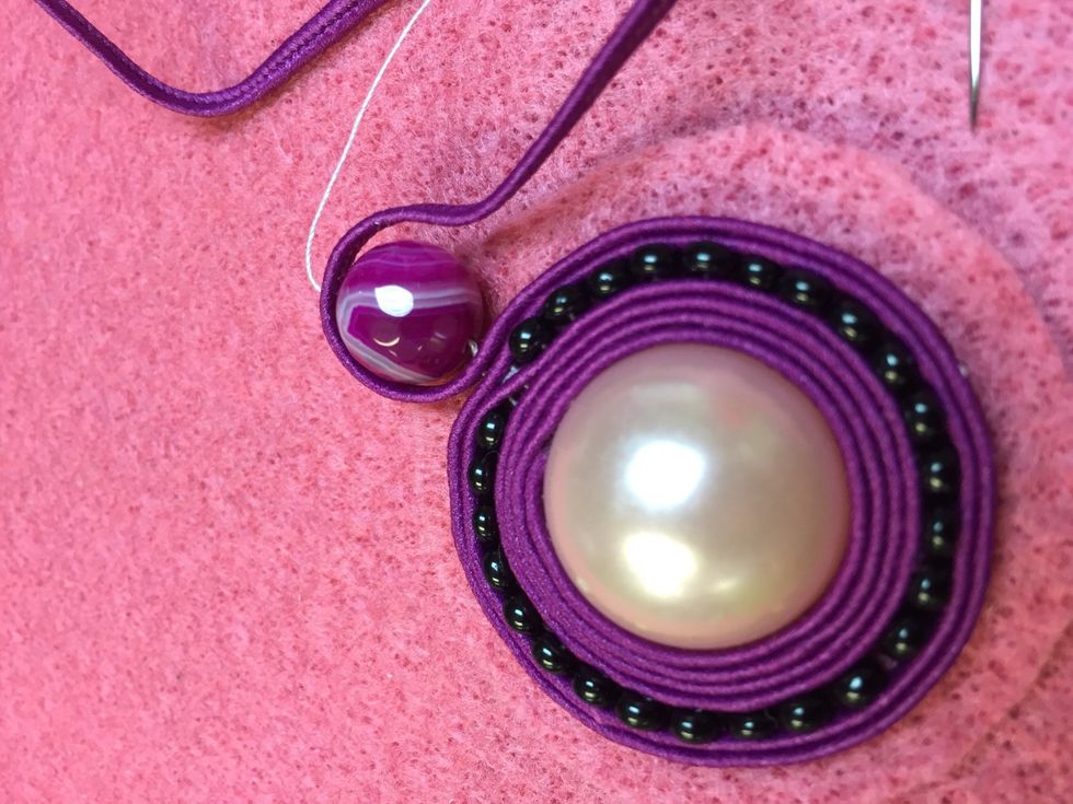 Add interest with a bigger glass bead matching your cording