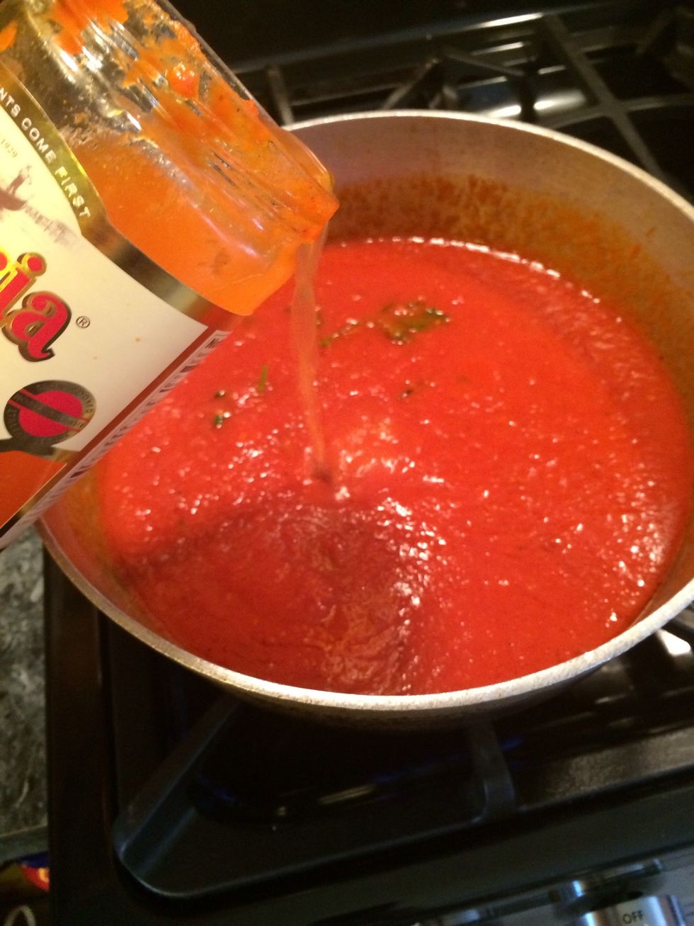 Add it to the sauce, let it come up to a slow simmer