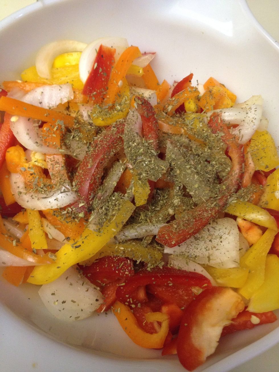 Add Italian seasoning and a dash of salt and pepper to your peppers and onions. Mix.