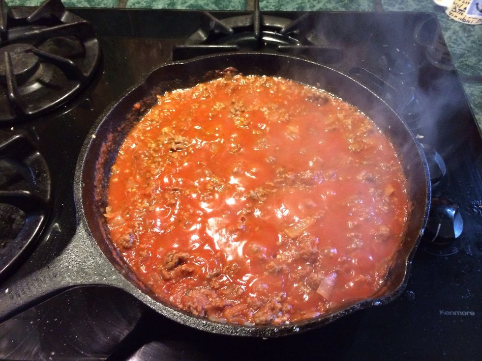 Add jar of sauce and paste and cook through the meat until it is thick. It's important to cook most of the liquid out to maintain a strong standing lasagna.