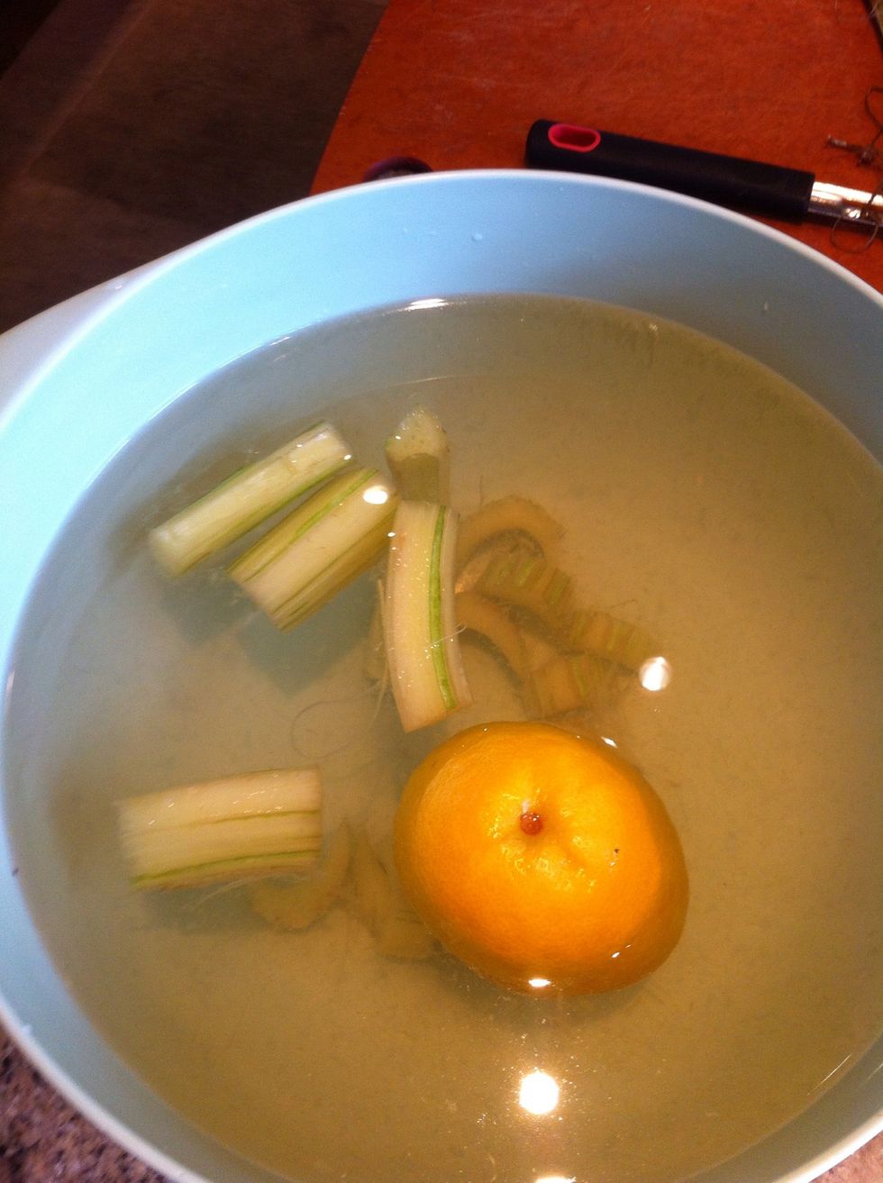 Add juice of half lemon and the lemon itself to a quart of water.   The acidified bath helps prevent discoloration.
