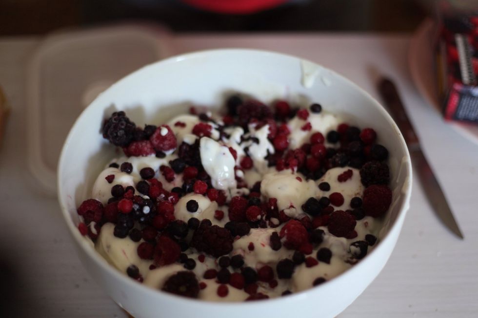 Add just a small handful of berries all around on top of the yoghurt. Now you might want to dig in right now, but please resist. We're not done yet... Almost ;)