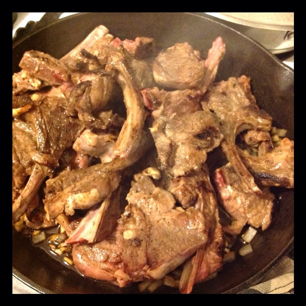 Add lamb chops back to skillet.