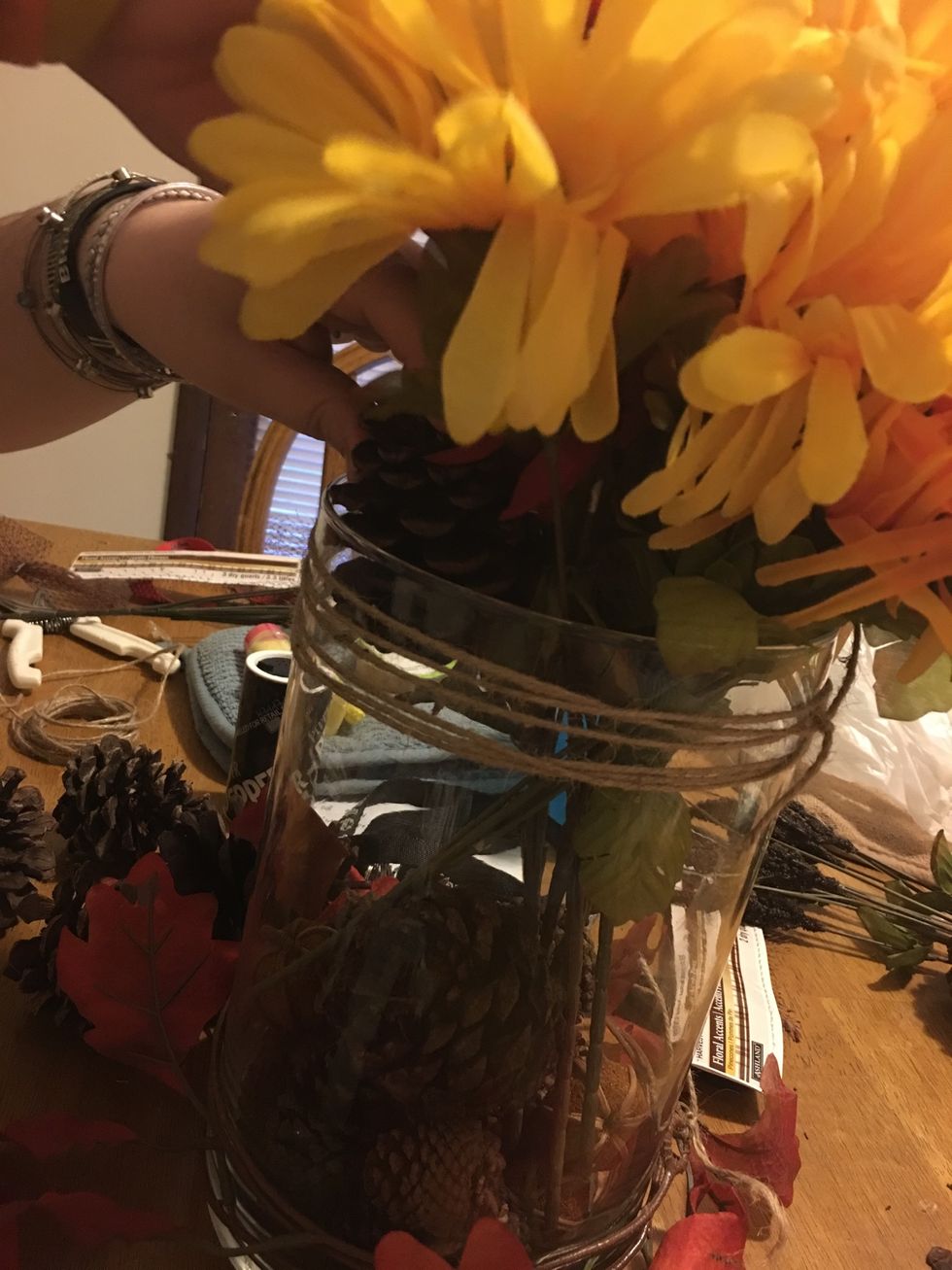 Add large pine cones around the flower arrangements.