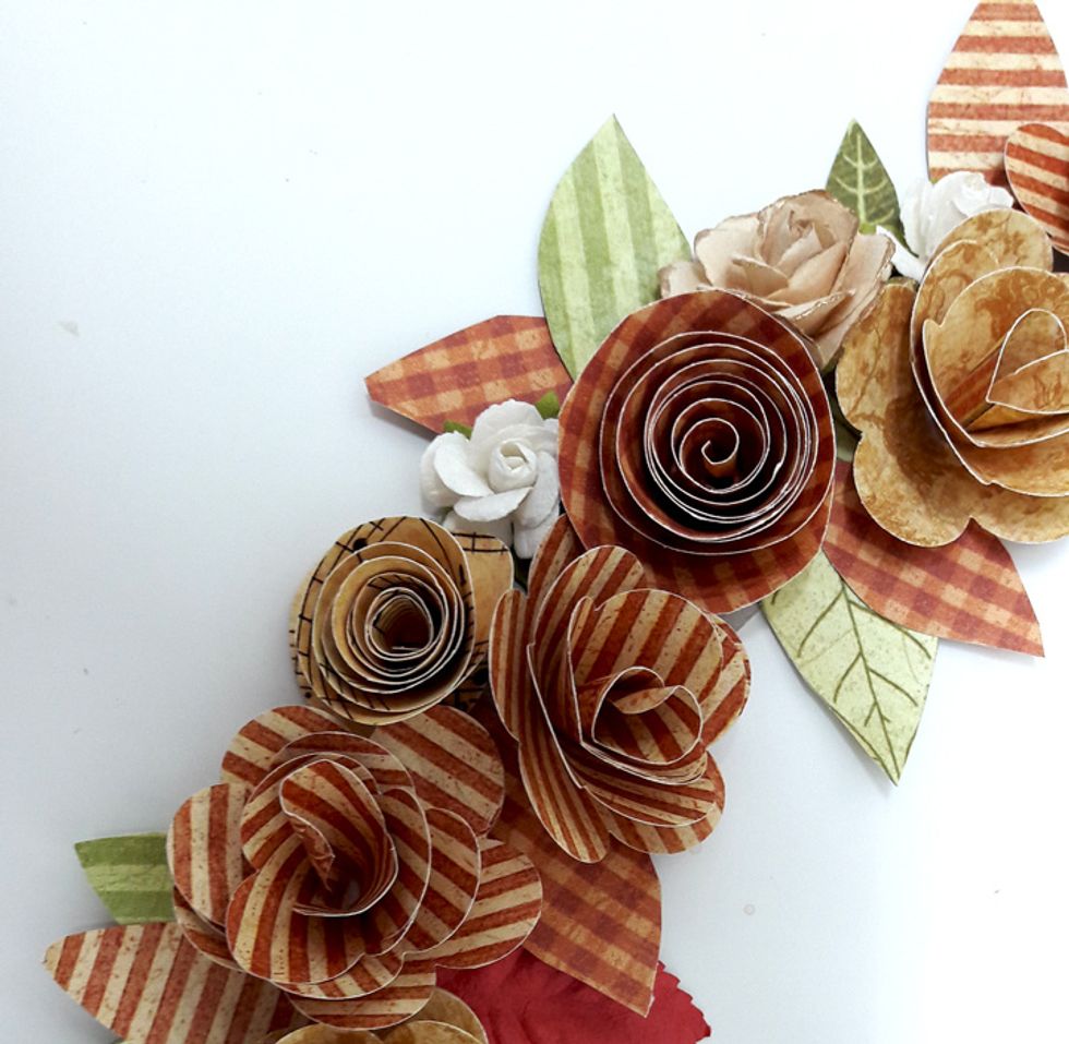 Add leafs and small paper flowers to the wreath. Cover all exposed chipboard.